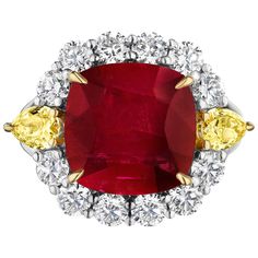 Centered upon a 7.32 Carat Cushion shaped Ruby, accompanied by AGL certificate stating it is heated. Flanked by Pear shaped Yellow Diamonds weighing 0.80 Carats. Surrounded by 12 Round Diamonds weighing 1.35 Carats Set in Platinum and 18 Karat Yellow Gold. Ruby And Diamond Ring, Yellow Diamonds, Ruby Diamond Rings, Golden Ring, Expensive Jewelry, Ruby Diamond, Gorgeous Jewelry, Yellow Diamond, Cocktail Rings