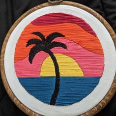 an embroidered palm tree on a black background