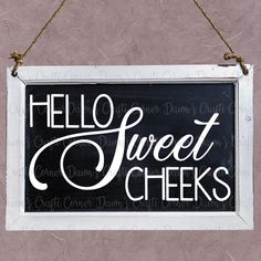 a black and white sign that says hello sweet cheeks hanging from a rope on a wall