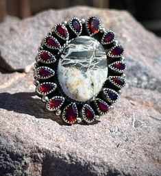 Exquisite Garnet and White Buffalo Couture Cluster Ring. The luxurious white buffalo is perfectly complemented by a stunning cluster of garnet gemstones. Available in sizes 5-12, with the option to leave a half size in the comments. Make a statement with this unique and elegant piece. White Buffalo, Garnet Gemstone, American Jewelry, Native American Jewelry, Cluster Ring, New Mexico, To Leave, Metal Working, Unique Pieces