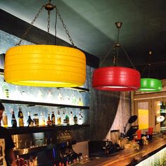 a bar with several lights hanging from the ceiling