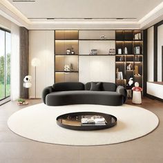 a modern living room with black and white furniture, large windows, bookshelves and a round coffee table