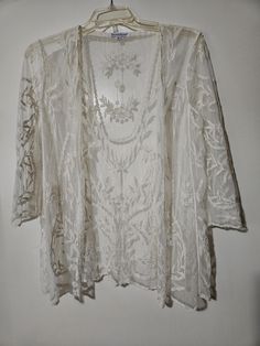 An airy open front very elegant sheer overlay jacket.  This lovely sheer jacket has a beautiful all over embroidery with 3/4 sheer sleeves and scalloped trim.  This can definitely be dressed up or down.   Thank you kindly for visiting SGI! Please check out other items listed on our site. https://www.etsy.com/shop/ShesgotitbySky Summer Wedding Long Sleeve Outerwear, Spring Wedding Lace Outerwear, Embroidered Lace Long Sleeve Outerwear, All Over Embroidery, Sheer Jacket, Mesh Jacket, Floral Overlay, Sheer Overlay, Scalloped Trim