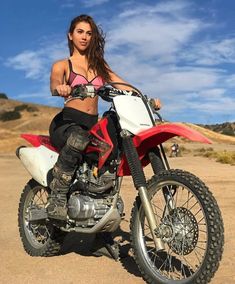 a woman sitting on top of a dirt bike