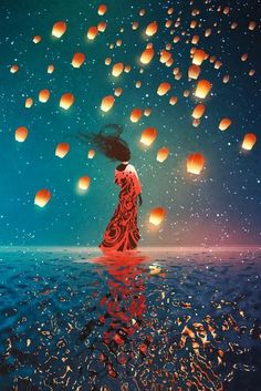 a woman standing in the water with lanterns floating above her and looking up into the sky