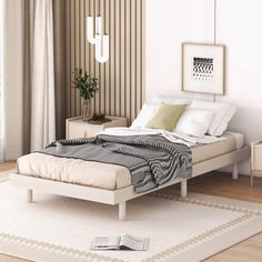 a white bed sitting next to a window in a bedroom on top of a wooden floor