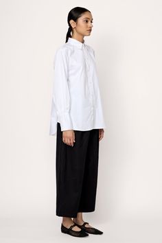 Introducing our timeless Museo Button-Up, inspired by classic menswear designs. Crafted from premium organic cotton poplin with a soft washer finish, this shirt embodies relaxed elegance. Its loose fit is complemented by curved hems at the front and back, along with a single box pleat at the back yoke for added sophistication. Wear it tucked into our Boyfriend Trouser for a polished look, or pair it effortlessly with our Barrel Leg Denim for a relaxed ensemble. Made with 100% Organic CottonHandm Boyfriend Trousers, Relaxed Elegance, Classic Menswear, Indian Textiles, Tunic Length, Mother Of Pearl Buttons, Polished Look, Classic Shirt, Cotton Poplin