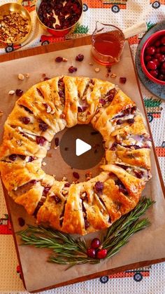 a cranberry danish on a cutting board surrounded by other foods and condiments