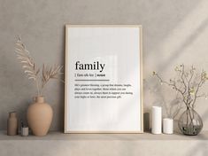 a family definition poster on a shelf with vases and candles in front of it