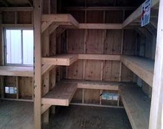 the inside of a wooden building with shelves and windows on each side of the room