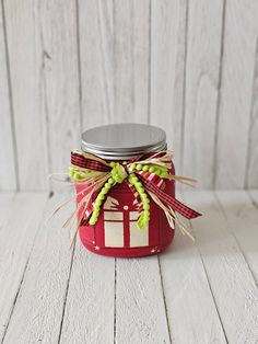 a mason jar with a red and white house on it