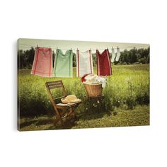 laundry hanging on clothes line with chair and table in grass field, canvas print wall art