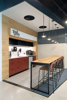 an open kitchen and dining area with bar stools