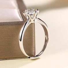 a diamond ring sitting on top of a book