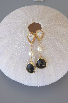 These are just gorgeous on!  A perfect gift for your bridal party or bridesmaids that they will also enjoy wearing after the wedding.  A Swarovski glass pearl (available in white or cream) is in between a tear drop rhinestone stud and a colored crystal drop (available in many colors).  These can be made in gold or silver as well.  They measure 1 3/4 inch in length including the rhinestone stud.  These are pictured in Emerald green.  Please see these two links to Look at more Color Options: https://www.etsy.com/shop/EverLuxe/search?search_query=5031&order=date_desc&view_type=gallery&ref=shop_search  https://www.etsy.com/shop/EverLuxe/search?search_query=5064&order=date_desc&view_type=gallery&ref=shop_search  Check out the Matching Necklace: https://www.etsy.com/listing/223510249/gold-chain- Gold Crystal Pearl Earrings For Wedding, Black Jewelry With Sparkling Stones For Wedding, Black Sparkling Stones Jewelry For Wedding, Black Sparkling Stones Wedding Jewelry, Glamorous Black Crystal Earrings For Wedding, Black Crystal Earrings For Wedding, Bridal Party Earrings, Bridesmaids Earrings, Wedding Silver