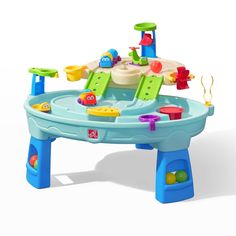 an infant's play table with toys on it