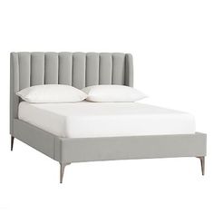 an upholstered bed with white pillows and gray headboard, against a white background