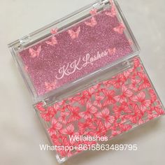 two pink and silver business cards in a clear case with butterflies on them, one has a monogrammed name