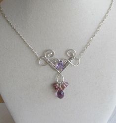 This delicate necklace is made of of woven silver wire. It features two beautiful amethysts and a cluster of lavender and pink sapphire rondelles.  It measures approx 19 inches long. Pink Amethyst Wire Wrapped Jewelry, Silver Amethyst Wire Wrapped Necklace, Silver Amethyst Briolette Necklace, Purple Briolette Wire Wrapped Jewelry, Elegant Amethyst Wire Wrapped Necklaces, Elegant Wire Wrapped Amethyst Necklace, Elegant Amethyst Wire Wrapped Necklace, Handmade Lavender Sterling Silver Necklace, Handmade Delicate Purple Necklace