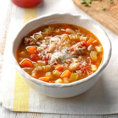 a white bowl filled with soup on top of a table