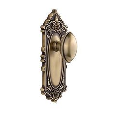 an antique style door handle with ornate design