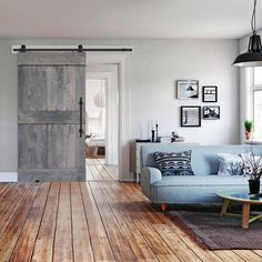 a living room filled with furniture and a sliding door in the middle of the room