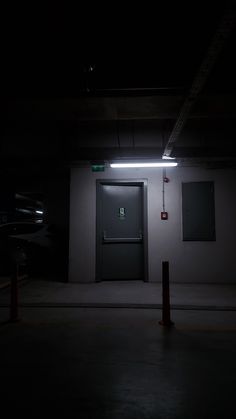 an empty parking garage at night with the door open and no one in it is present