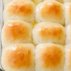 rolls in a baking pan with melted cheese on top and the words, how to make homemade buns