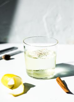 a glass filled with liquid sitting on top of a table