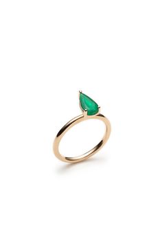 a gold ring with a green tear shaped stone on the front and side, set against a white background