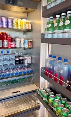 an open refrigerator filled with lots of sodas and water bottles next to each other