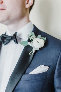 a man in a tuxedo with a boutonniere on his lapel