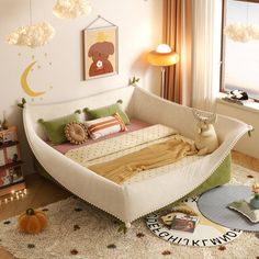 a child's room with a bed and toys on the floor in front of a window