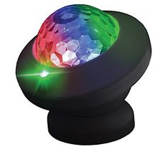 a colorful light up ball on top of a black object with green, red, and blue lights