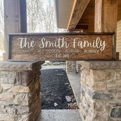 a wooden sign that says the smith family on it's front entrance to a home