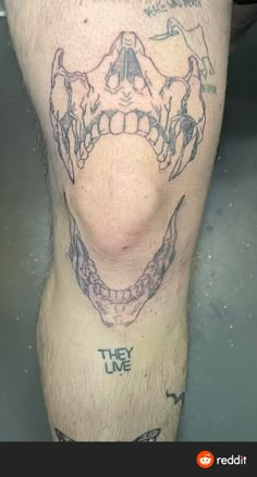 a man's leg with tattoos on it