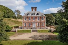 an aerial view of a large red brick house