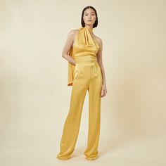 Elevate your style with our chic jumpsuit featuring an elegant draped scarf detail. This modern asymmetrical one-piece with an open back and slightly flared leg offers a sleek and polished look. Perfect for any dressy occasion whilst looking effortlessly sophisticated. Do not wash. Do not bleach. Low Iron. Dry clean only. Mustard Outfits, Chic Jumpsuit, Jumpsuit Chic, Elegant Drapes, Pearl Jewellery Earrings, Independent Designers Fashion, Gifts For New Moms, Polished Look, Yellow Orange