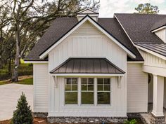 a white house with black roof and windows