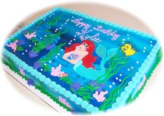 a birthday cake with an image of the little mermaid on it