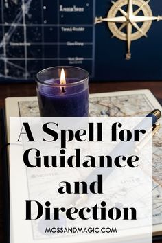 a spell for guidance and direction book with a lit candle on the table next to it