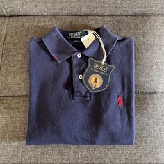 Certified By An In-House Archivist As A Ralph Lauren Original. Rare, Limited Edition Polo Shirt. Updated With Hand-Sewn Hallmarks Applied In New York At The Collar And The Hem. Hallmark Thread Matches The Signature Embroidered Pony. Includes A Hang Tag Ensuring Authenticity. This Authentic Vintage Item May Include Markings And Distressing, Which Enhance Its One-Of-A-Kind Character. Hand-Sewn Hallmark At The Right Side Of The Collar. Hand-Sewn Hallmark At The Right Hem. Signature Embroidered Pony Designer Blue Long Sleeve Top, Designer Blue Cotton Polo Shirt, Navy Fitted Polo Collar Top, Navy Fitted Tops With Spread Collar, Navy Fitted Top With Spread Collar, Designer Navy Collared Top, Blue Long Sleeve Polo Shirt For Work, Navy Top With Collar For Work, Blue Polo Collar Workwear Shirt