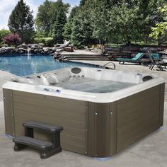 a hot tub sitting next to a swimming pool