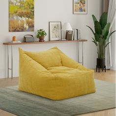 a yellow bean bag chair sitting on top of a rug