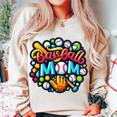 a woman with blonde hair wearing a baseball mom sweatshirt