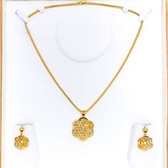 Experience the epitome of luxury with our Ritzy Floral 22K Gold Pendant Set. Crafted from 22k yellow gold, weighing an exquisite 10.1 grams, this set embodies unparalleled elegance. The pendant, measuring 1.5" in length, is complemented by matching earrings, 1.2" in length, featuring convenient push back posts. Embrace the allure of this 3-piece set, chain not included. PRODUCT DETAILS Gold Purity(karat): 22k Gold Weight(grams): 10.1 Item Finish: Yellow Gold Pendant Length: 1.5" Matching Earring Yellow Gold 22k Jewelry Sets For Celebration, 22k Yellow Gold Jewelry Sets For Celebration, Celebration 22k Yellow Gold Jewelry Sets, Elegant 22k Yellow Gold Jewelry Sets, Gold Pendant Set, Yellow Gold Pendants, 22k Gold, Pendant Set, Matching Earrings