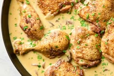 chicken and mushroom soup in a skillet with parsley on the side, ready to be eaten