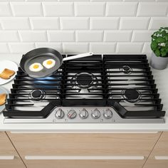 a stove top with eggs and toast on it