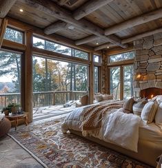 a large bed sitting inside of a bedroom on top of a wooden floor next to a window