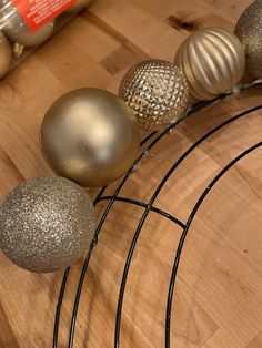 some ornaments are sitting on top of a metal wire rack and wooden table with other items in the background